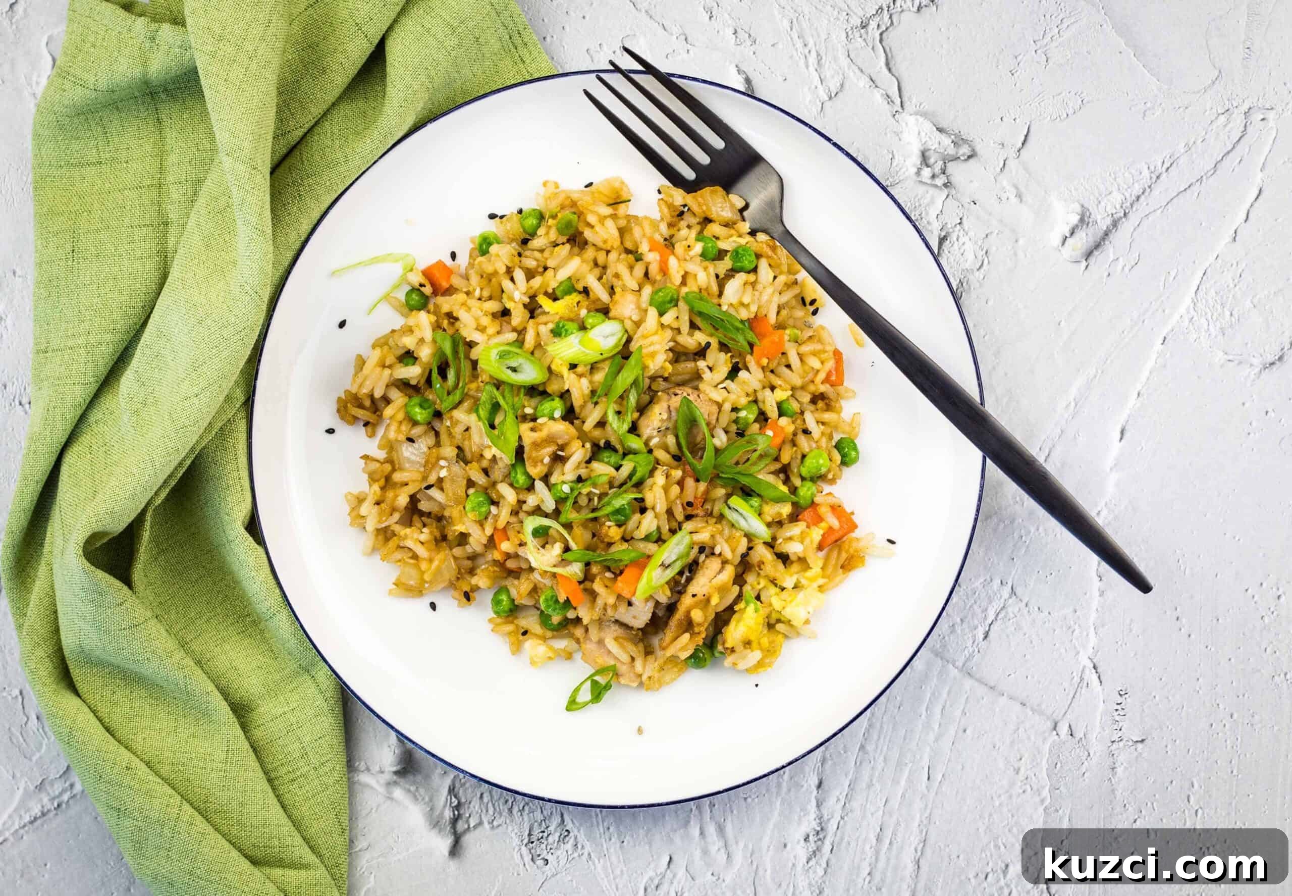 33 Fall Dinner Recipes Packed With Comfort Food Favorites 20 Chicken fried rice on a white plate with a green napkin.