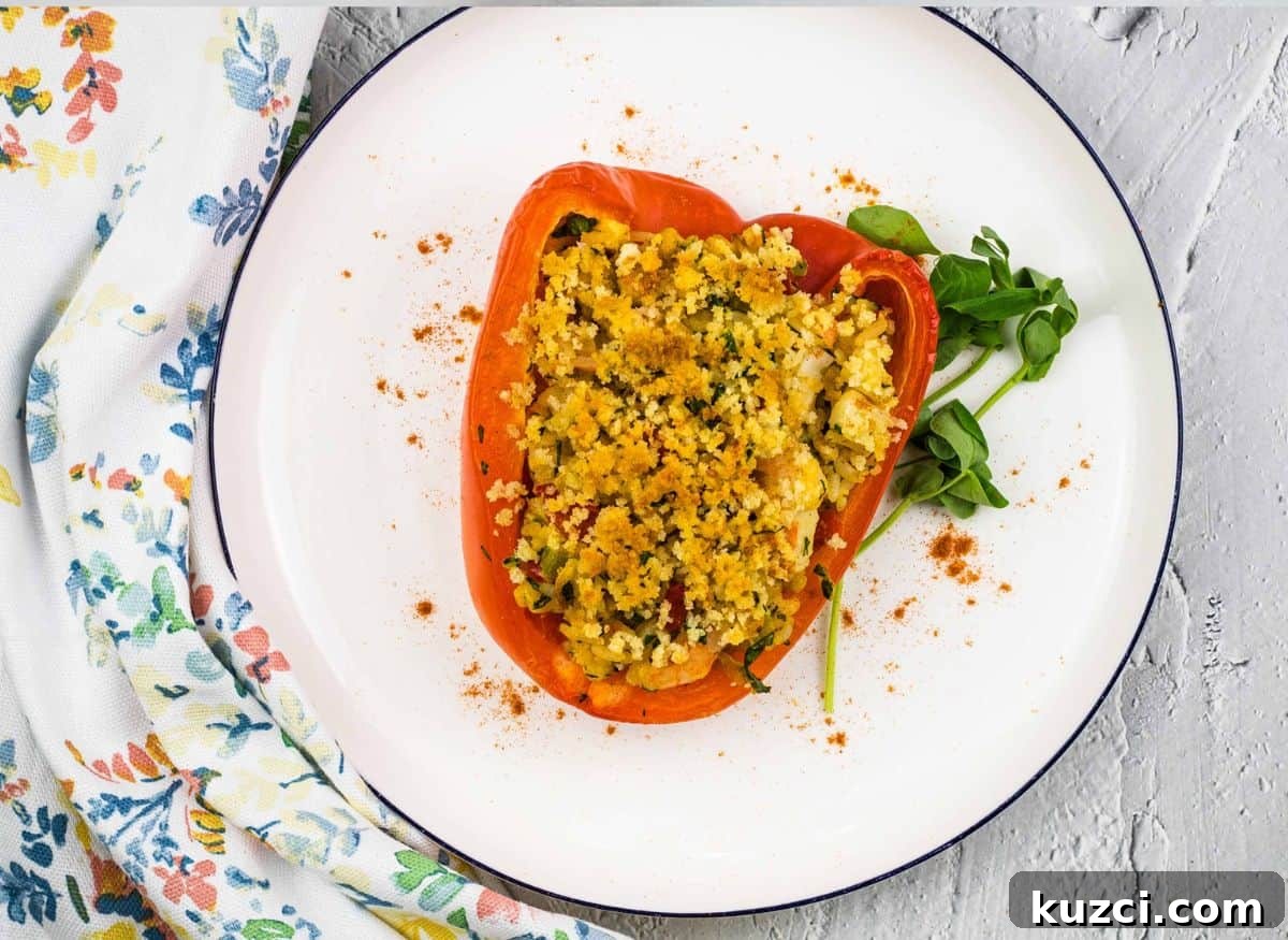 33 Fall Dinner Recipes Packed With Comfort Food Favorites 21 Seafood Stuffed Bell Peppers on a white plate.
