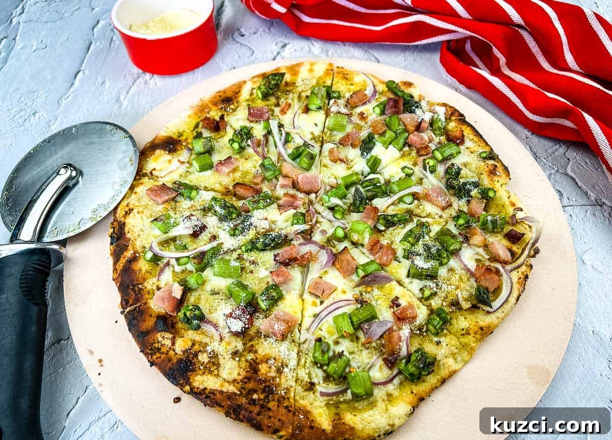 33 Fall Dinner Recipes Packed With Comfort Food Favorites 26 A pizza with ham and asparagus on a pizza stone.