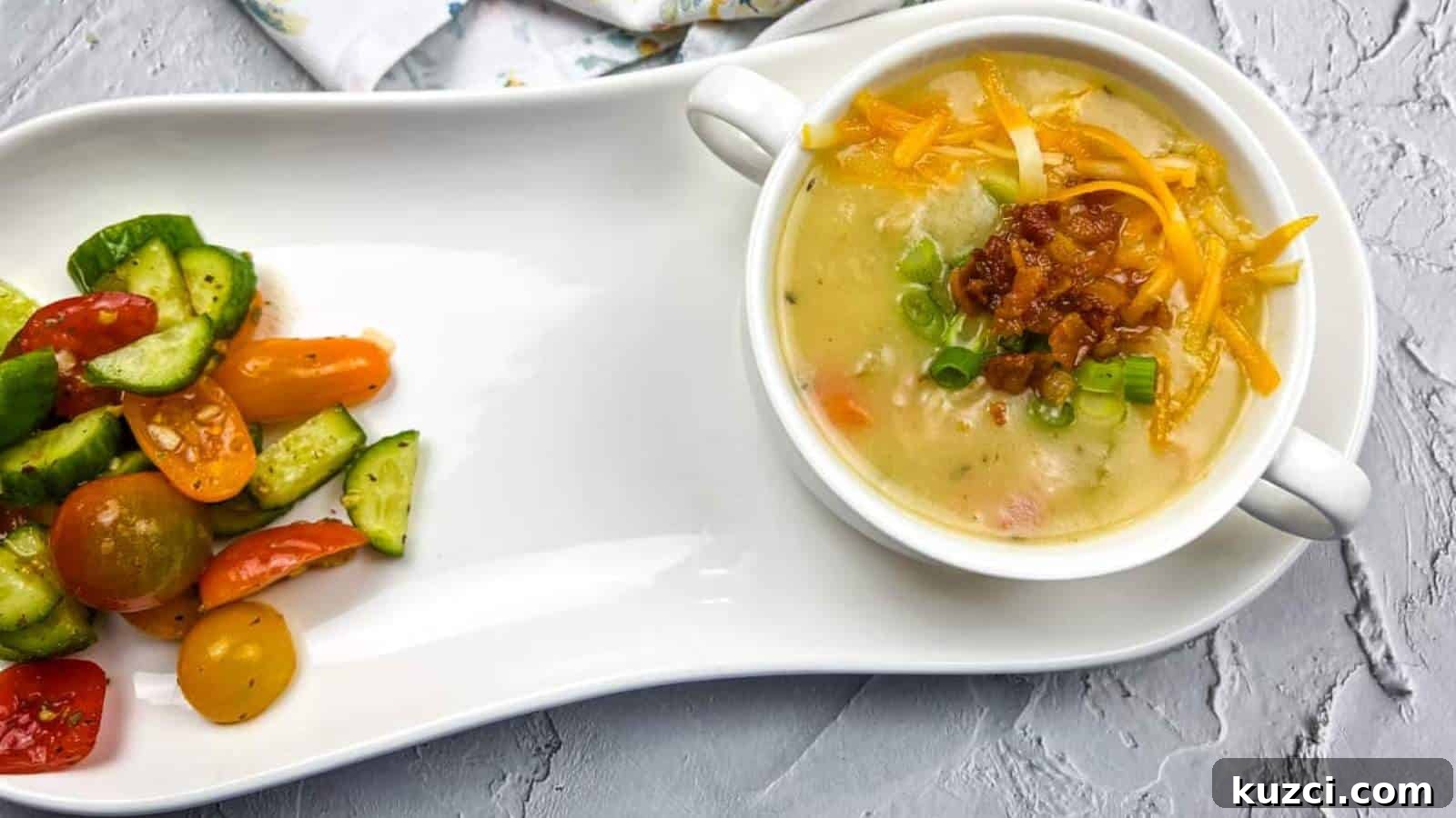 33 Fall Dinner Recipes Packed With Comfort Food Favorites 27 A white plate with fully loaded baked potato soup and vegetables on it.