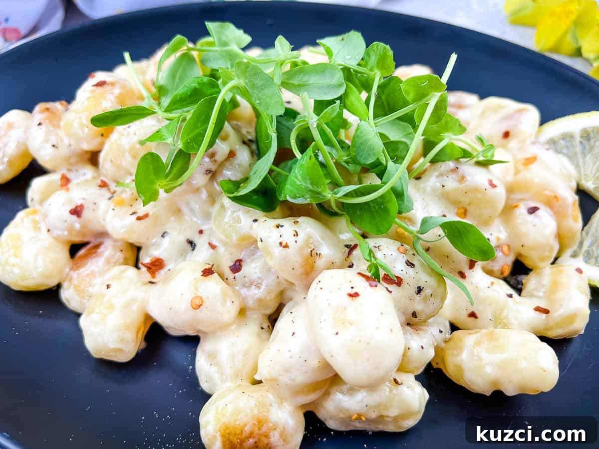 33 Fall Dinner Recipes Packed With Comfort Food Favorites 28 Gnocchi in Lemon-Parmesan Sauce on a black plate.