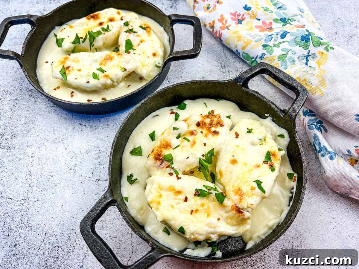 33 Fall Dinner Recipes Packed With Comfort Food Favorites 31 Giant Cheese Stuffed Pasta Shells in two black serving dishes.