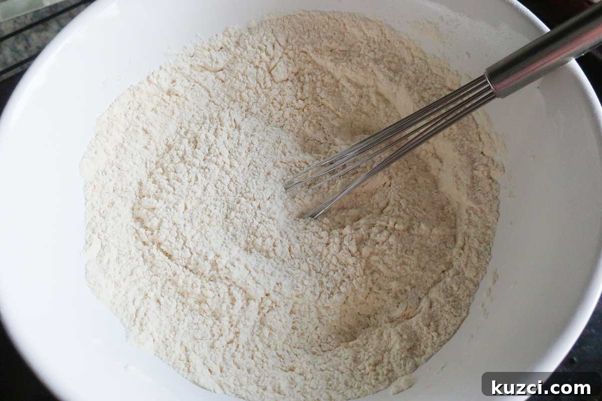 whisking various flour in a bowl