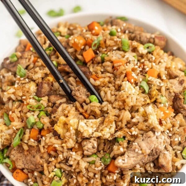 Savory Ham Fried Rice with Eggs and Vegetables 12 Chinese fried rice in a bowl with chopsticks.