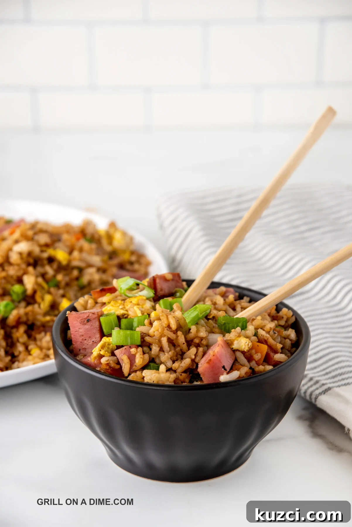 Savory Ham Fried Rice with Eggs and Vegetables 8 Ham fried rice in a black bowl with chopsticks