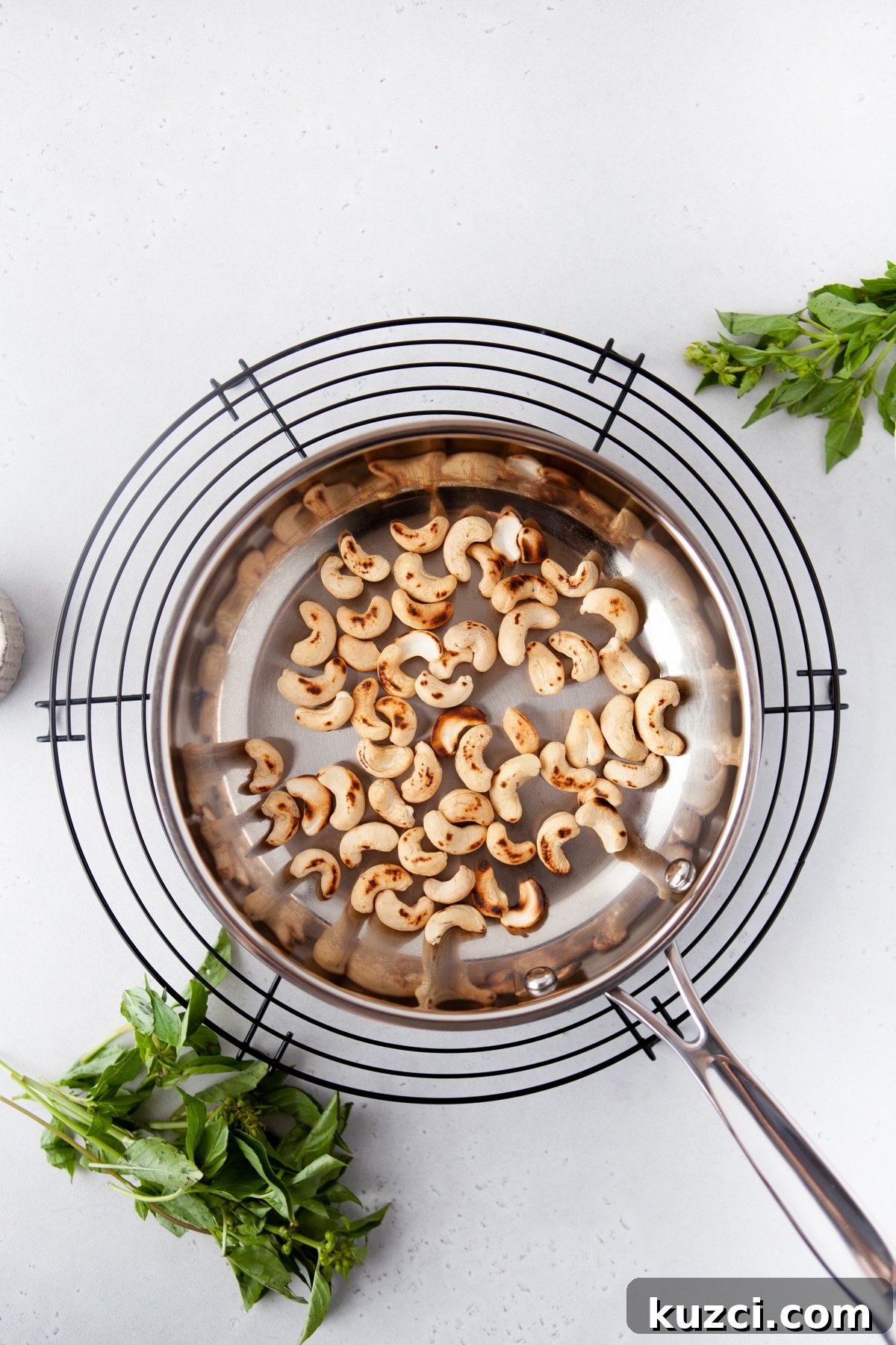 Trader Joe's Copycat Black Truffle Cashew Pesto Recipe 5 Cashews being toasted in a small pan in preparation to make cashew pesto sauce.