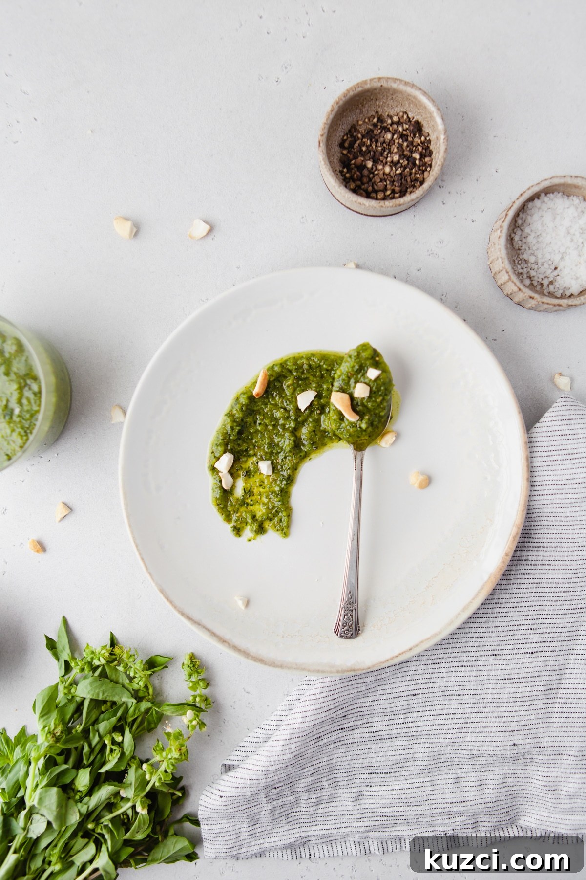 Trader Joe's Copycat Black Truffle Cashew Pesto Recipe 7 An image of homemade cashew pesto sauce smeared on a white plate.