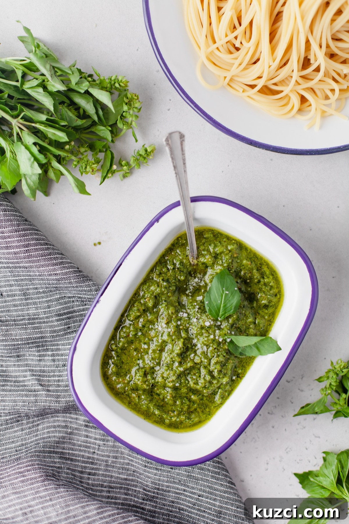 Trader Joe's Copycat Black Truffle Cashew Pesto Recipe 8 An overhead image of homemade cashew pesto sauce with a dish of noodles in the background.