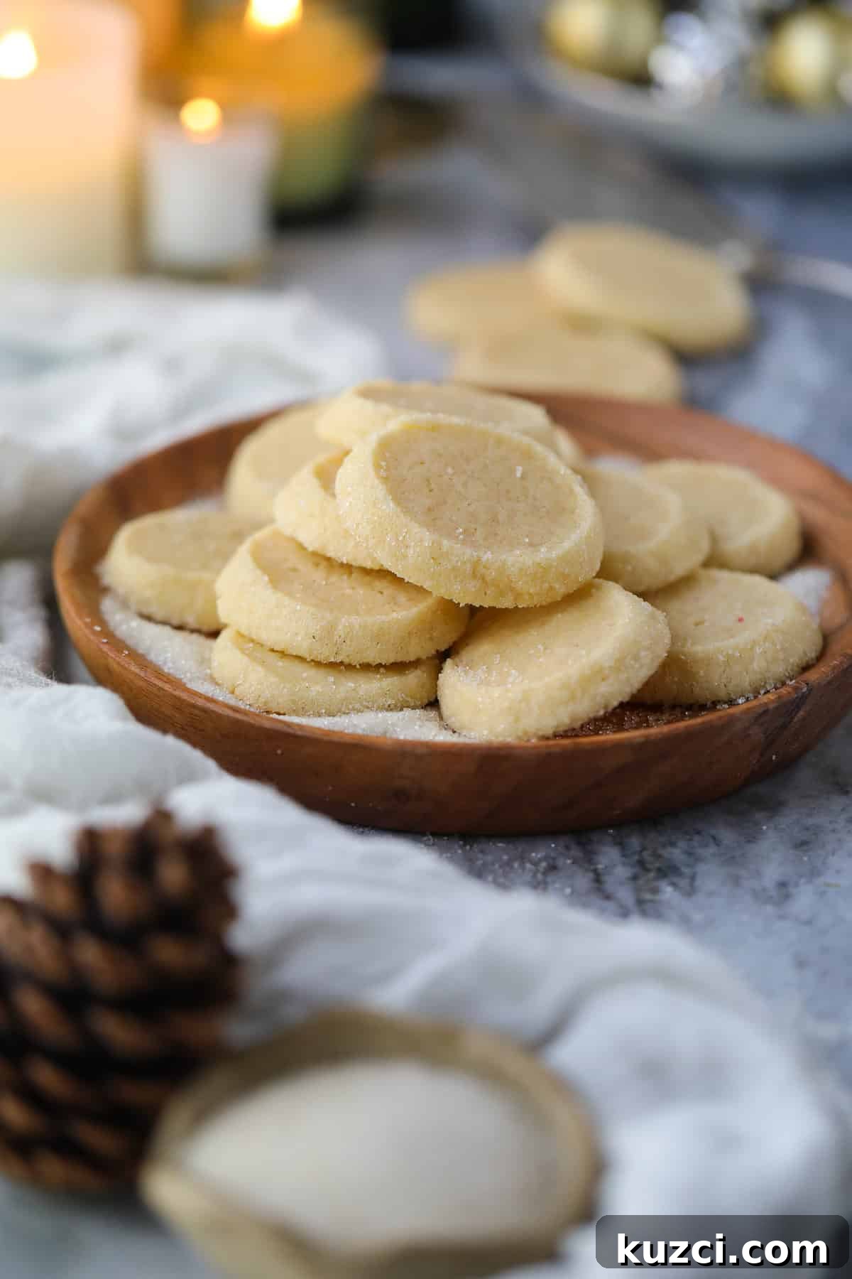 Cardamom Butter Cookies Recipe 11 Cardamom butter cookies arranged on a wooden platter sitting on a table top.