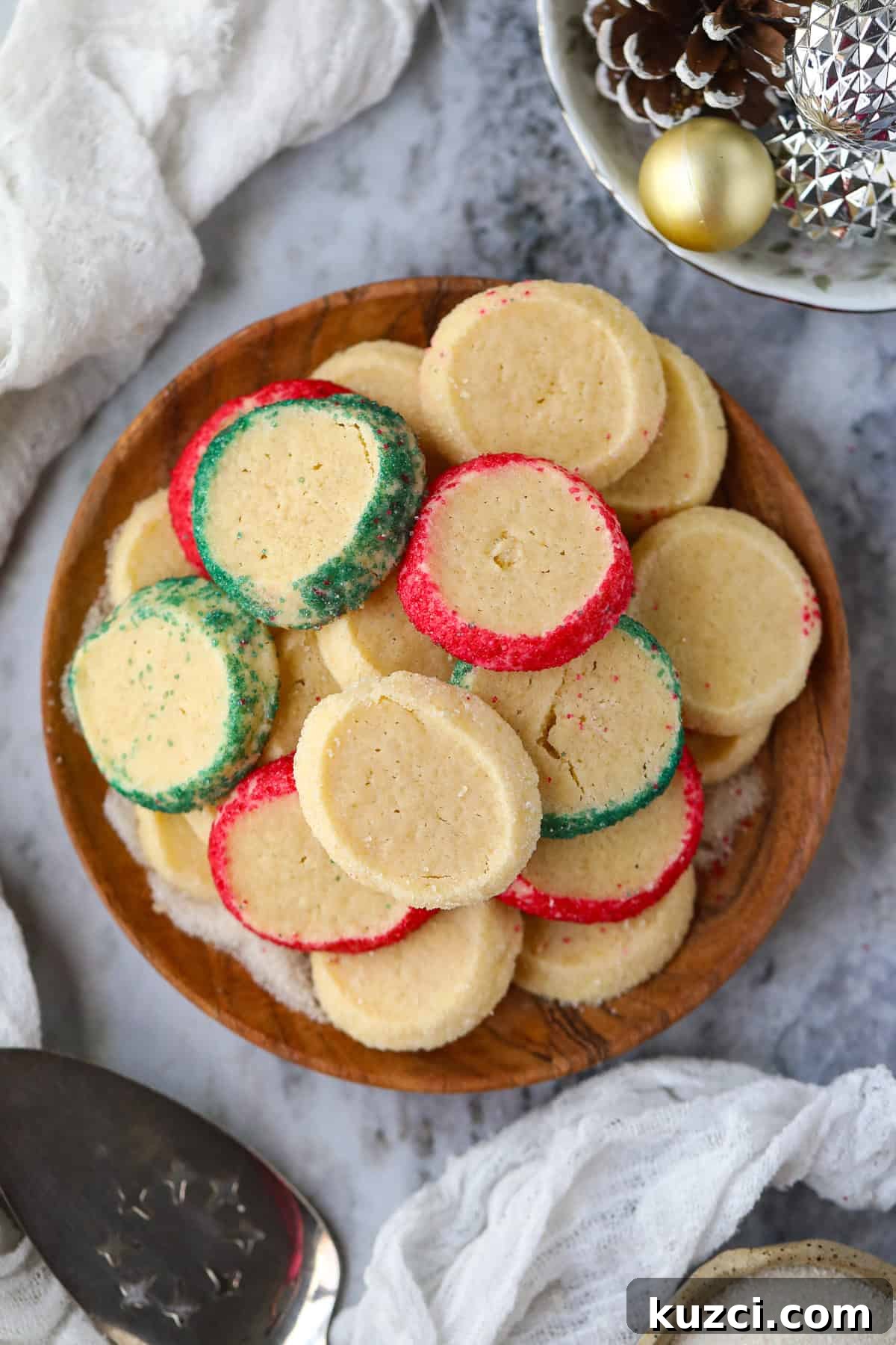 Cardamom Butter Cookies Recipe 10 Cardamom butter cookies arranged on a wooden platter sitting on a table top.
