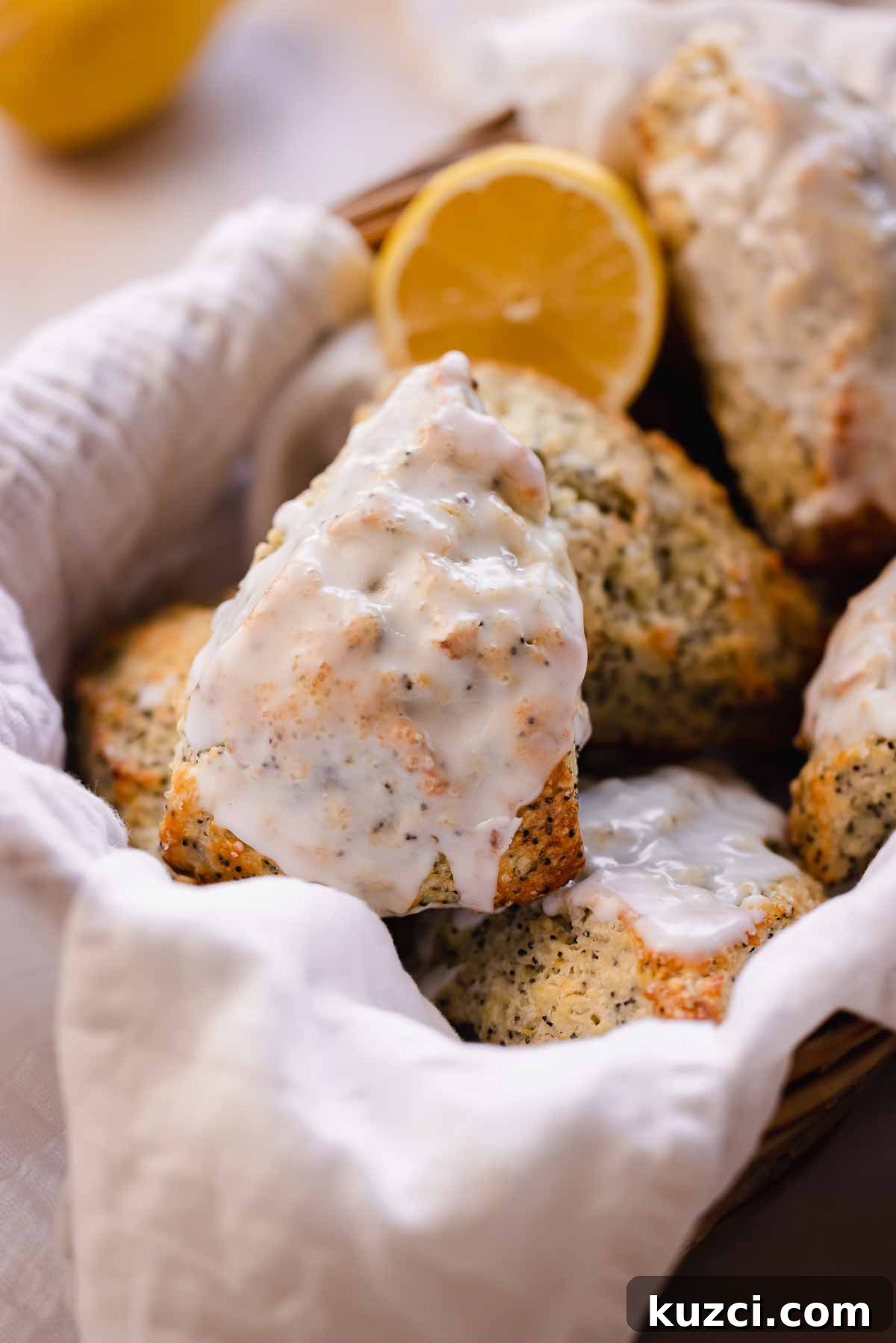 Lemon Poppy Seed Scones with Zesty Glaze 14 lemon poppy seed scone in basket with white glaze