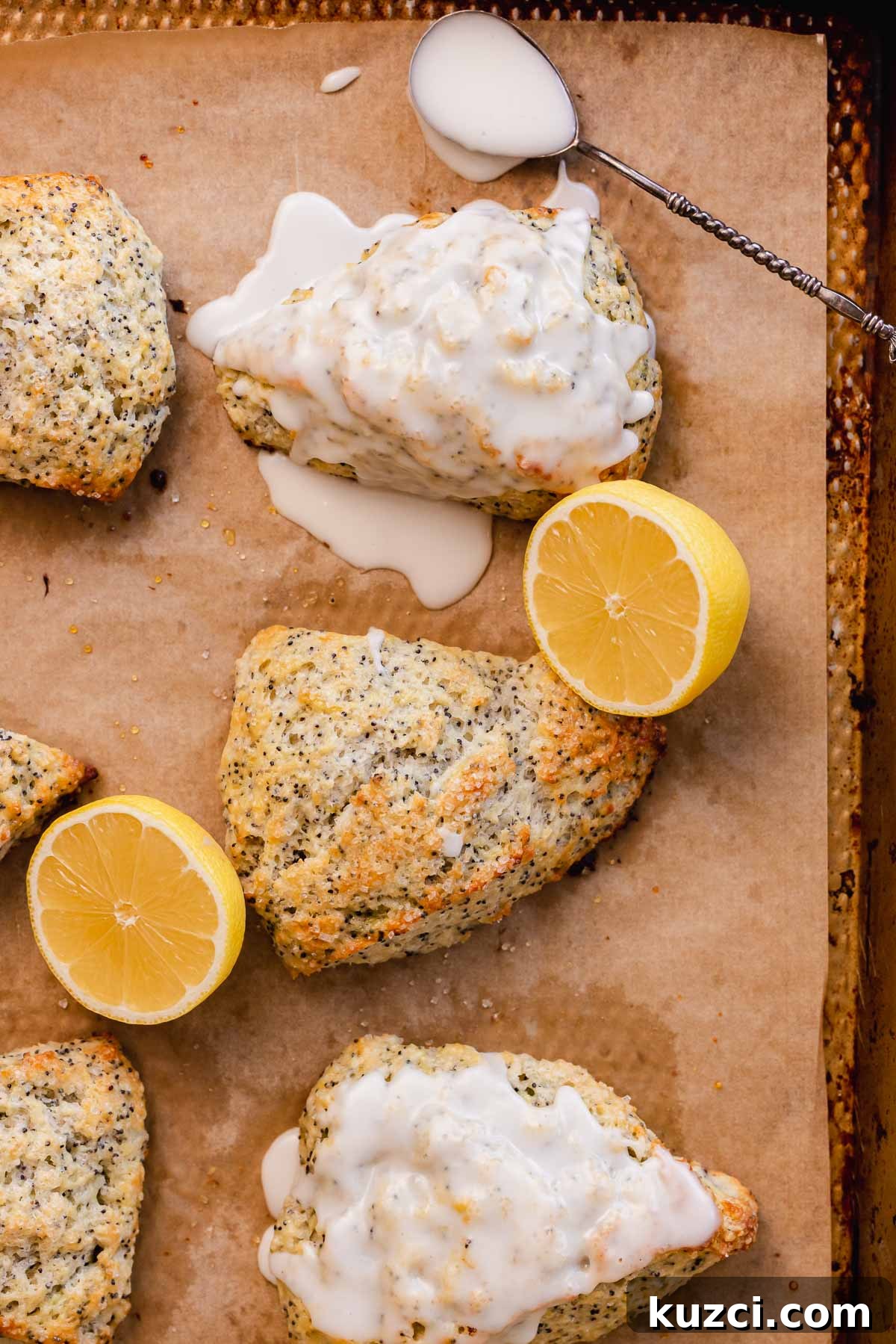 Lemon Poppy Seed Scones with Zesty Glaze 15 baked and glazed lemon poppy seed scone on parchment paper with lemon glaze