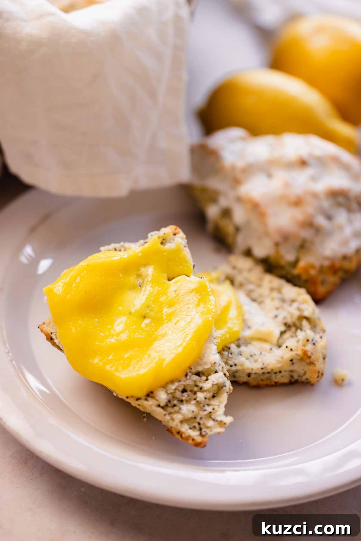 Lemon Poppy Seed Scones with Zesty Glaze 16 closeup of lemon poppy seed scone with smear of lemon curd