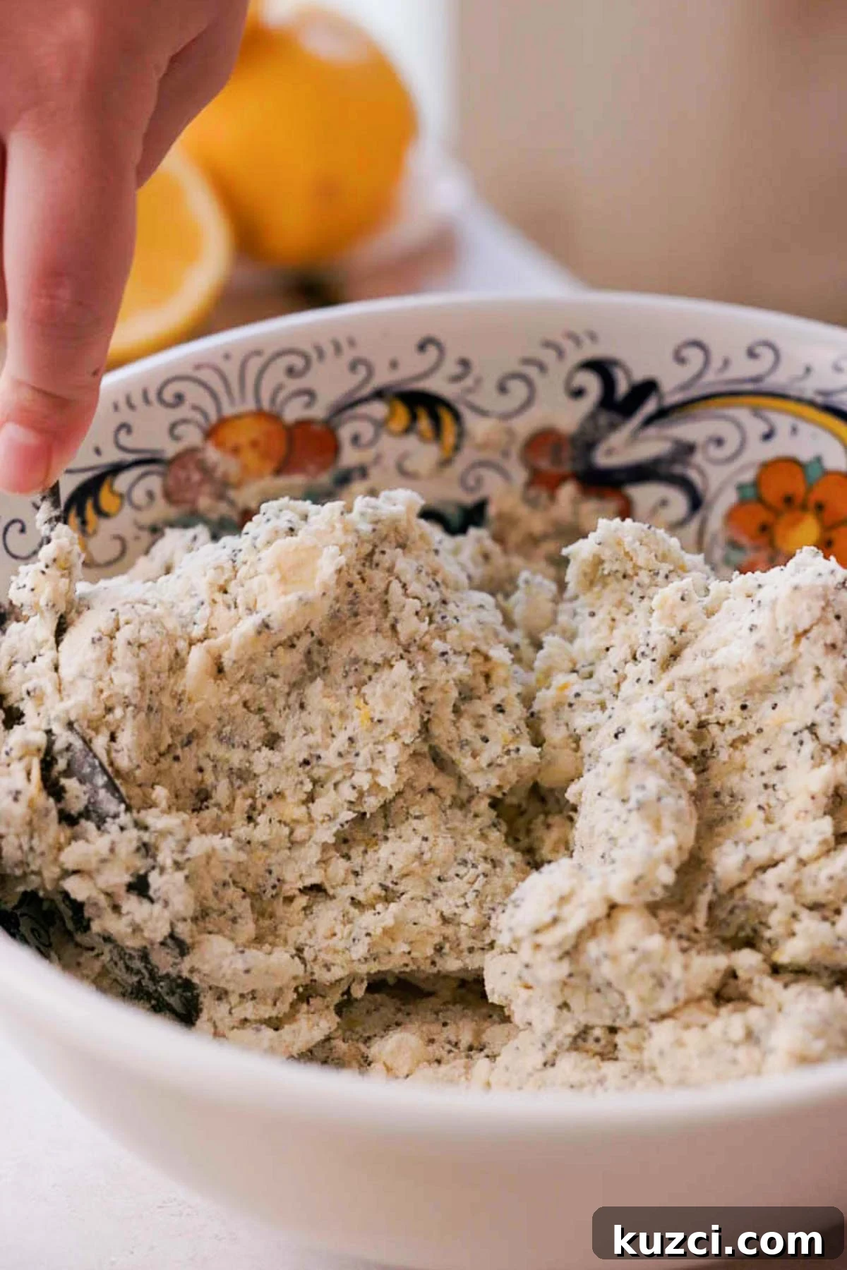 Lemon Poppy Seed Scones with Zesty Glaze 7 stirring together scone dough with a spoon