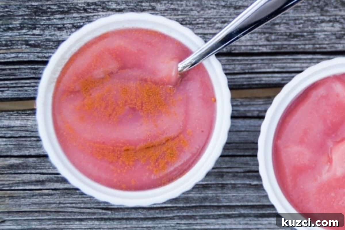 How to Make Unsweetened Applesauce from Scratch 2 Pink applesauce in a small white bowl.