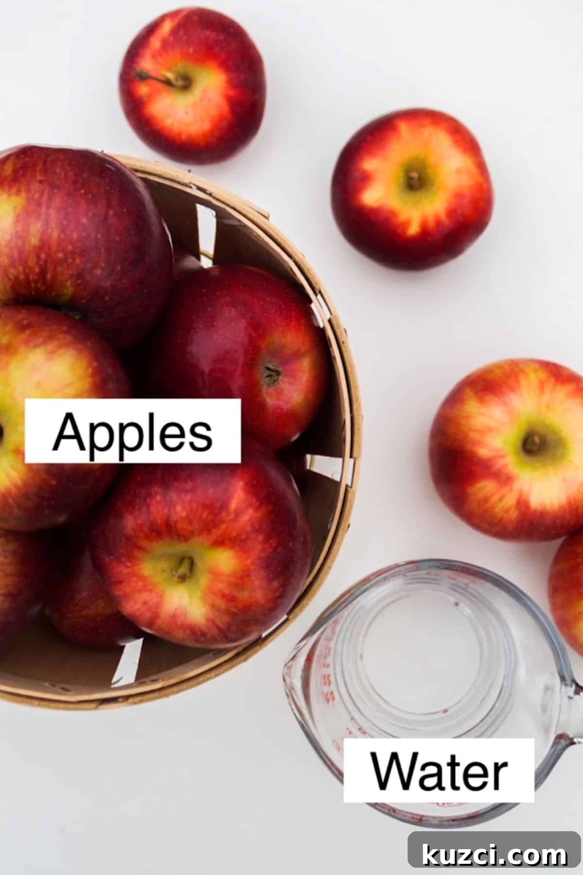 How to Make Unsweetened Applesauce from Scratch 3 Apples in a basket and water in a measuring cup.