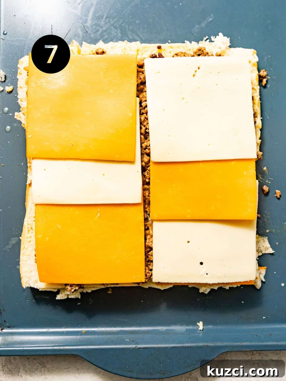 cheese slices placed on top of the ground beef filling.