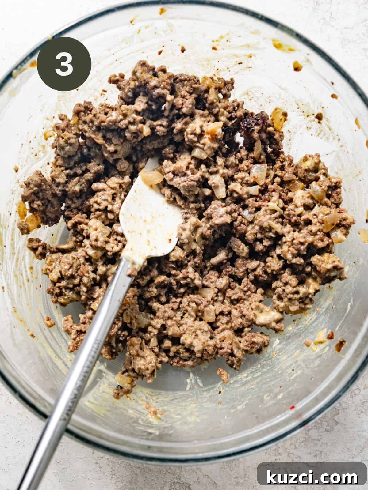 ground beef mixed with burger sauce in a mixing bowl.