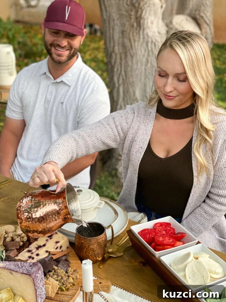 Lady pouring copper pitcher with guy smiling