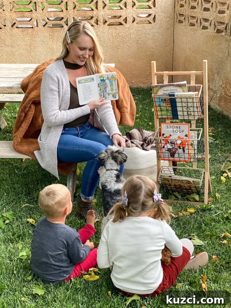Lady reading books outside to two kids