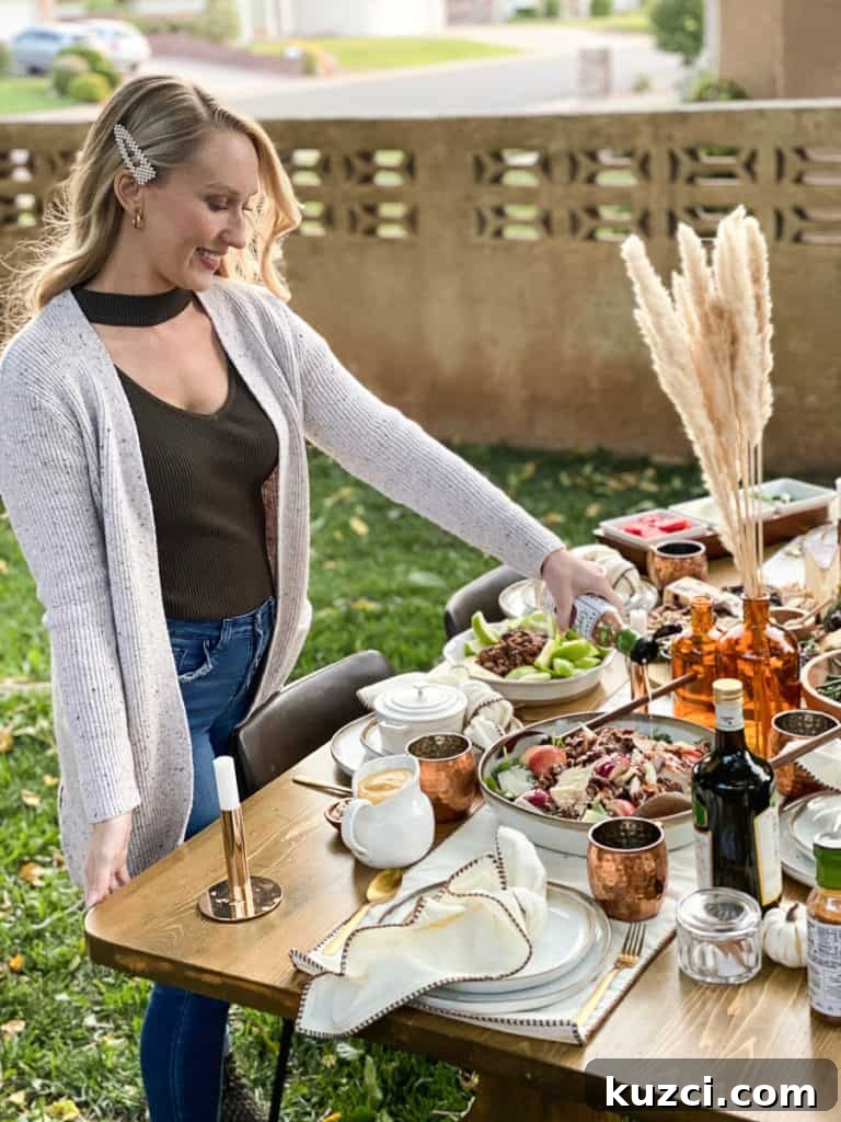 Gal pouring dressing on fall harvest salad