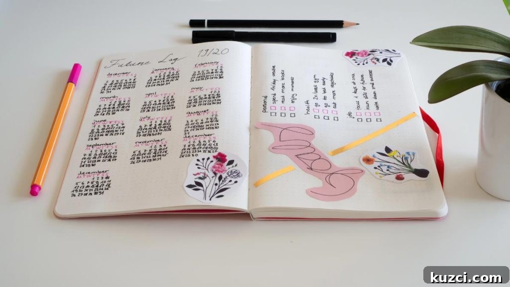 bullet journal and pencils on white table