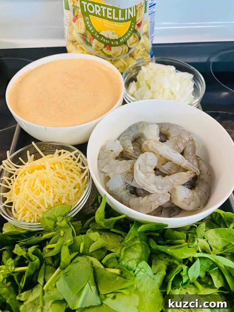 Blackstone Shrimp Tortellini with Red Pepper Sauce 4 prepped ingredients on a tray ready for the griddle