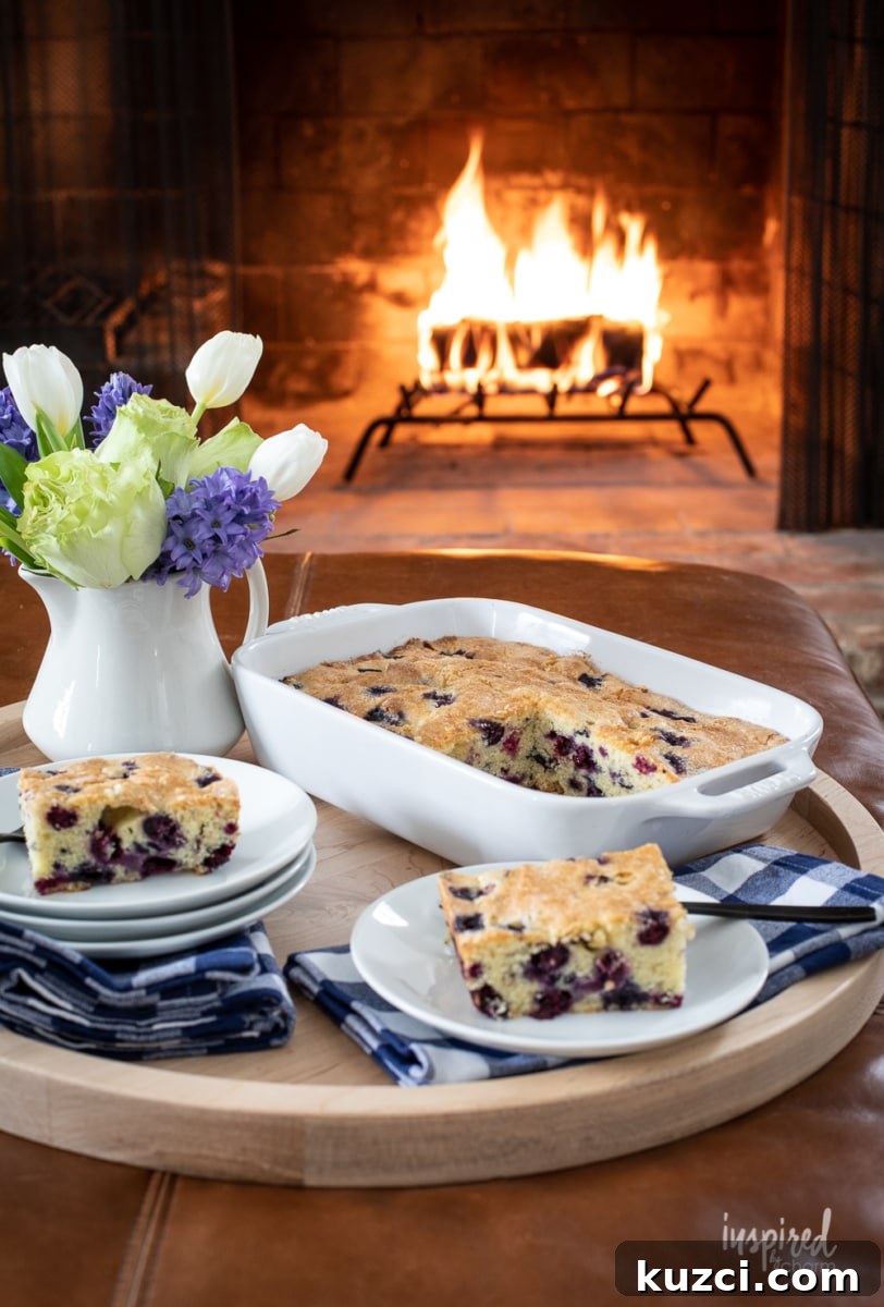 Moist Blueberry Cake Recipe with Lemon Glaze 3 a baking dish of fresh blueberry cake with a fire in the background