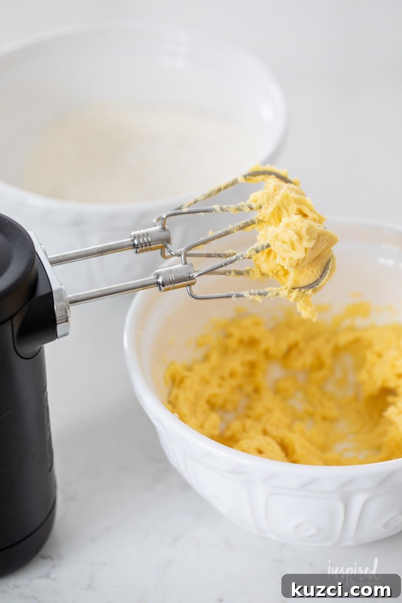 Moist Blueberry Cake Recipe with Lemon Glaze 5 mixing together butter, sugar and egg yolks