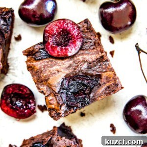 Fudgy Cherry Brownies with Dark Chocolate 14 A cherry brownie topped with a fresh cherry cut in half.