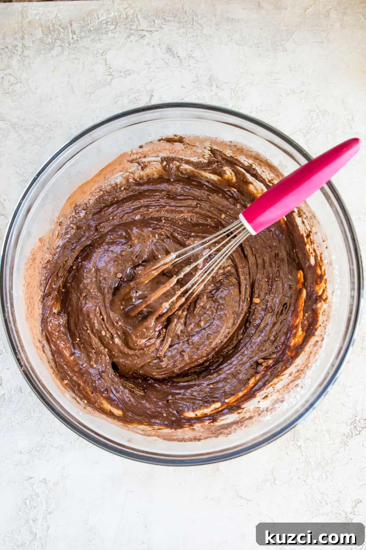 Fudgy Cherry Brownies with Dark Chocolate 6 A glass bowl with a chocolate batter in it.