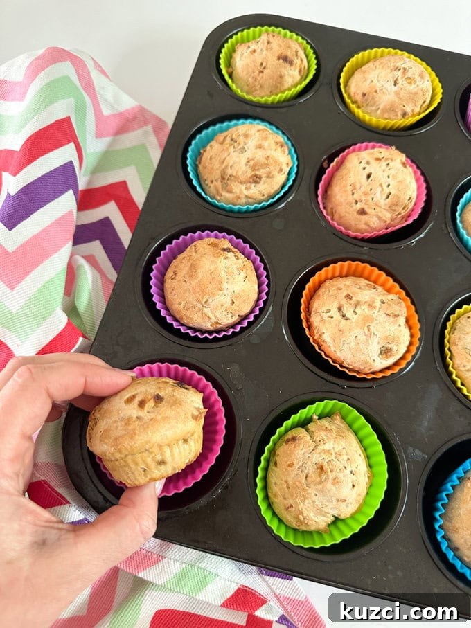 3 Ingredient Banana Muffins fresh out of the over in there brightly colored silicone muffin cases.