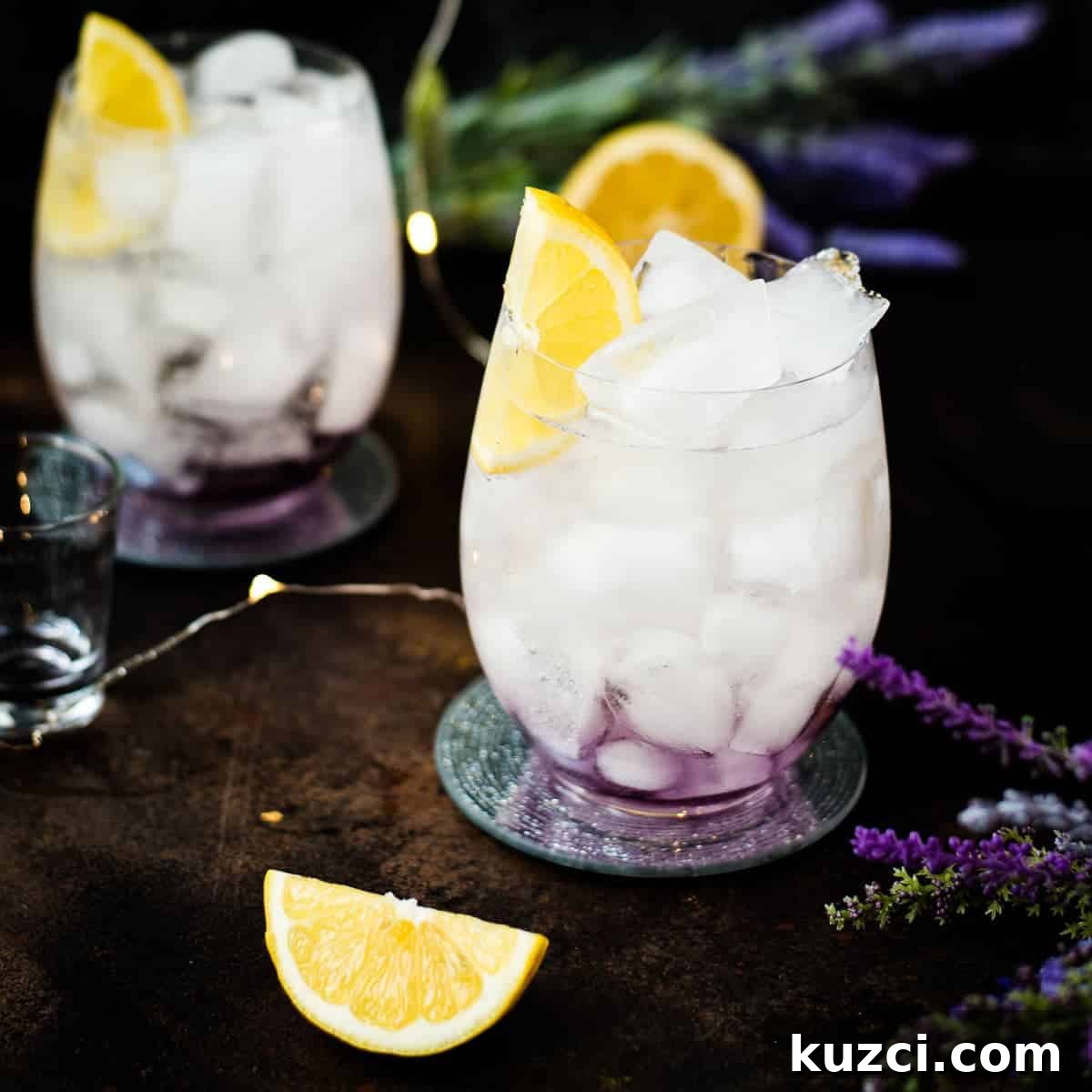 Lavender spritz with Prosecco garnished with a lemon wedge.