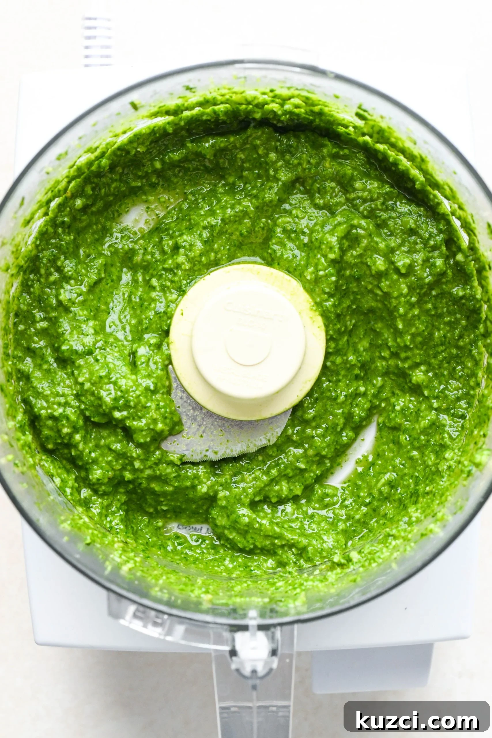 Homemade Basil Pesto - Vegan-Friendly Recipe 7 How to make homemade basil pesto: Finished creamy pesto in the bowl of food processor.