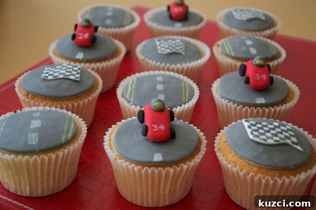 12 cupcakes decorated with road markings and grand prix red cars