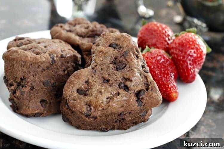 Chocolate Chocolate Chip Biscuits recipe with Homemade Strawberry Butter homemade heart shaped chocolate biscuits on plate with fresh strawberries