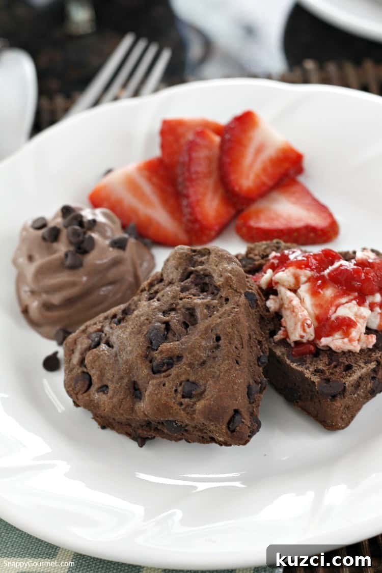 Chocolate Biscuits and Strawberry Butter recipe - heart shaped from scratch biscuits Chocolate Chocolate Chip Biscuits with Strawberry Butter and fresh strawberries on plate