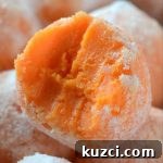 Image of white chocolate orange creamsicle truffle with a bite