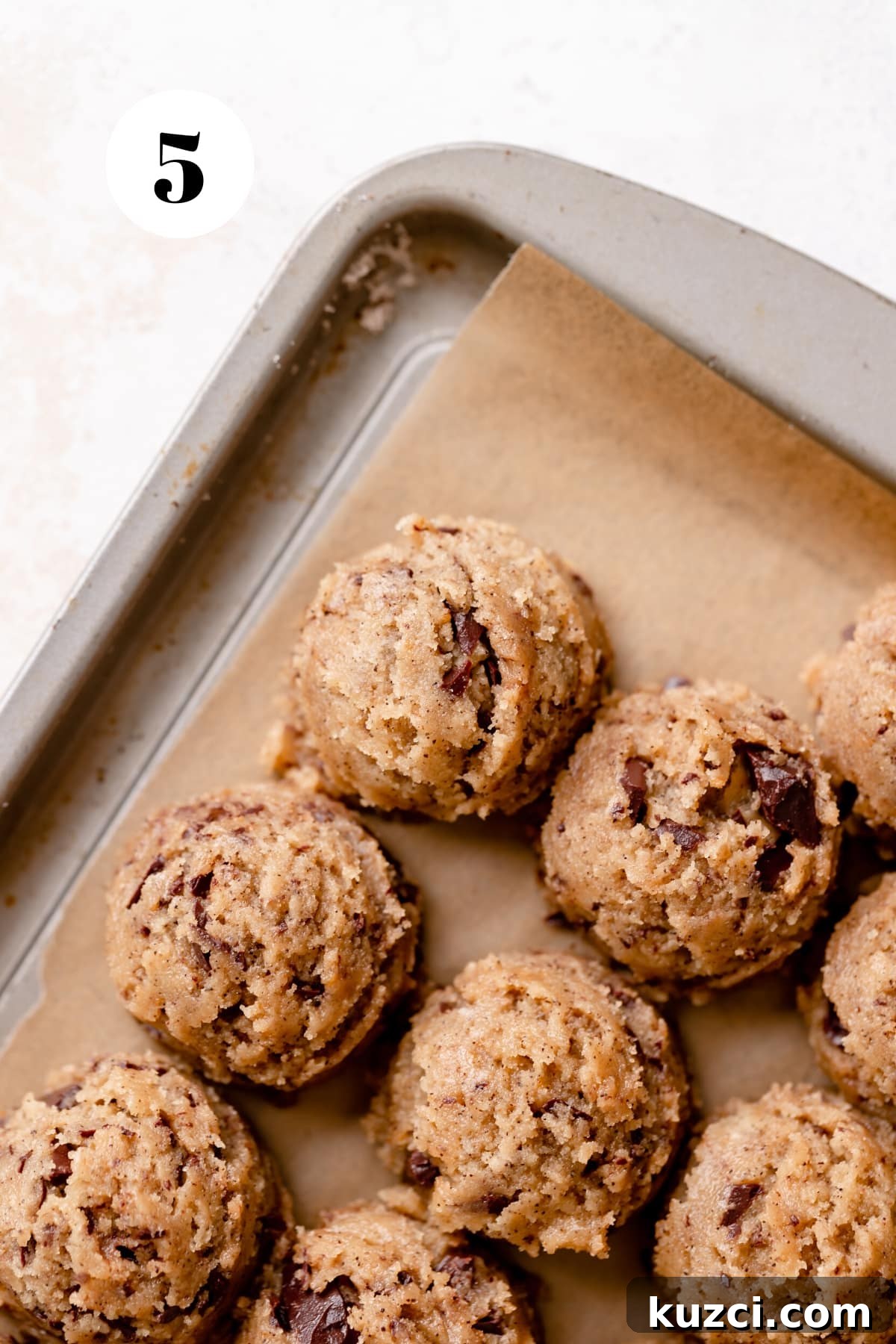 Chewy Espresso Chocolate Chip Cookies 5 espresso chocolate chip cookie dough balls on a baking tray.