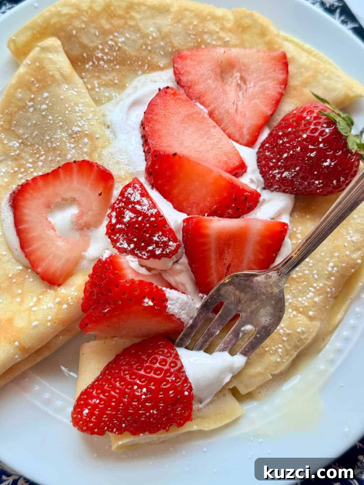 showing the plated crepes with a bite taken out