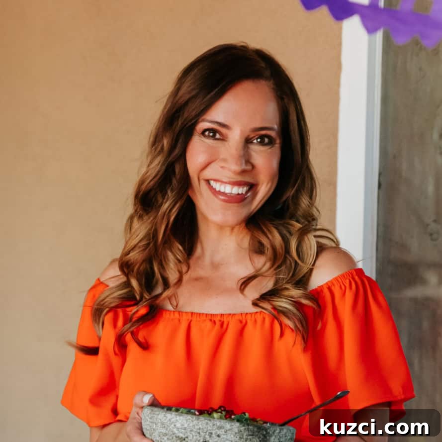 Witches' Brew Sangria: Spooky Halloween Cocktail 3 Yvette Marquez muy bueno Mexican food blogger in an orange dress holding a molcajete.