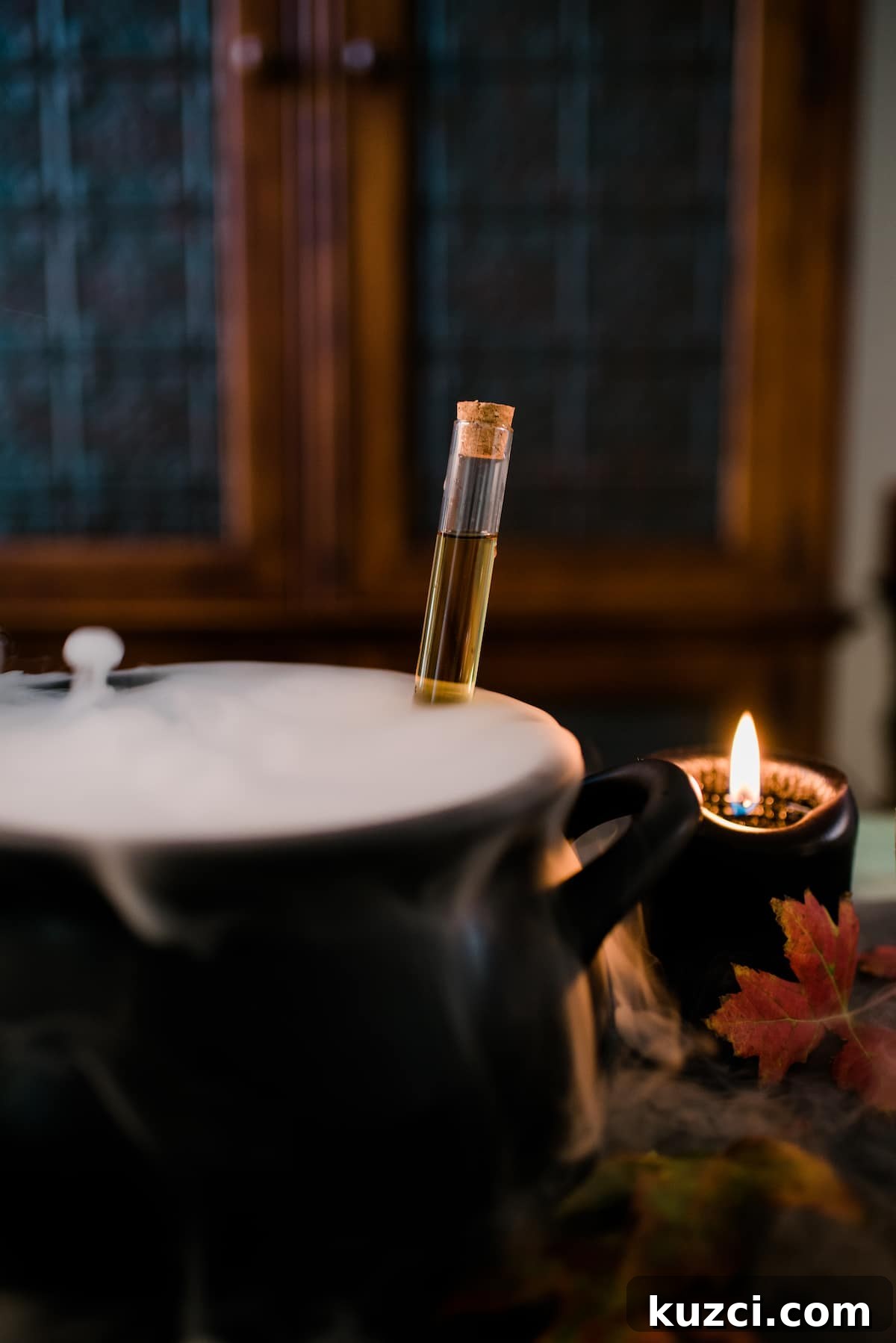 Witches' Brew Sangria: Spooky Halloween Cocktail 5 Cauldron of Witch’s Brew Halloween Sangria bubbling with dry ice fog beside a lit black candle.