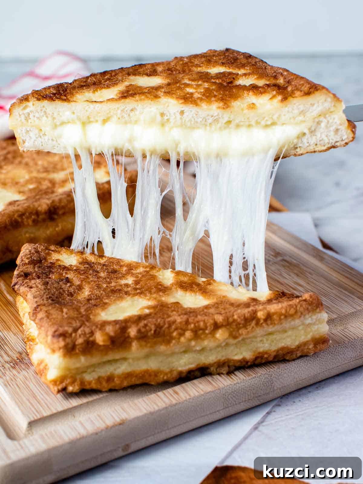 Mozzarella in carrozza cut in half and showing cheese pull.