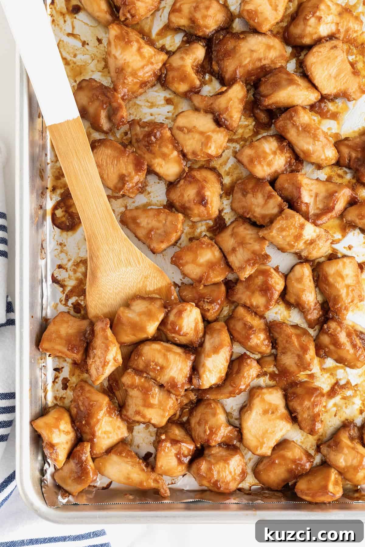 A sheet pan of baked orange chicken.