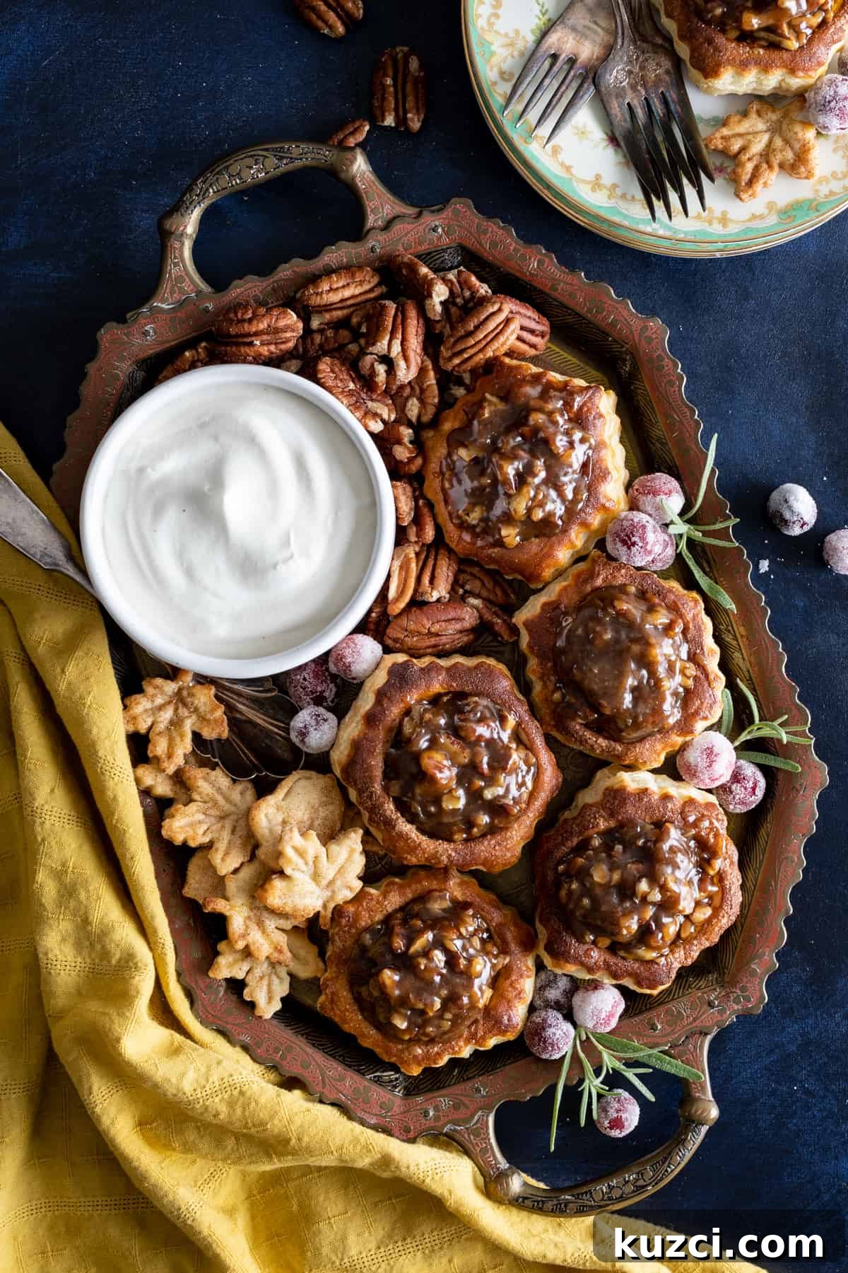 Homemade Whipped Cream Recipe in 5 Minutes 6 A bowl of chantilly cream on a tray with mini pecan tarts.