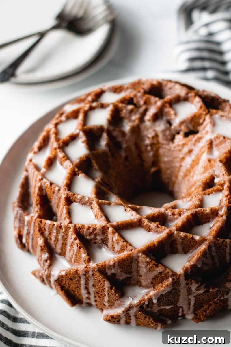 sour cream coffee cake, bundt cake on a plate, icing dripping down sides