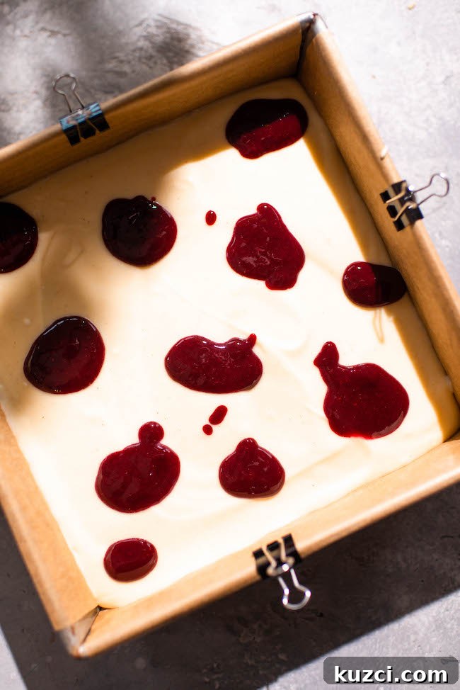 Swirling blackberry jam into mascarpone cheesecake filling