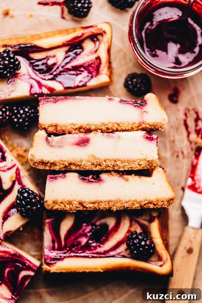 Sliced blackberry mascarpone cheesecake bars ready to serve
