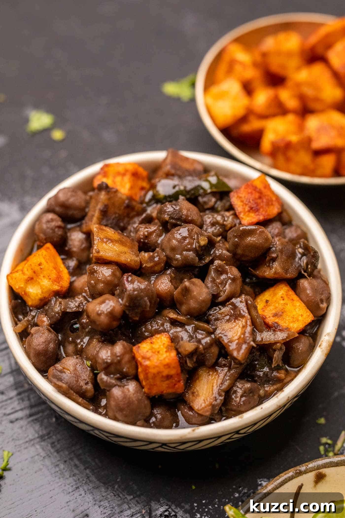 Bowl of pindi chole served with spicy fried aloo