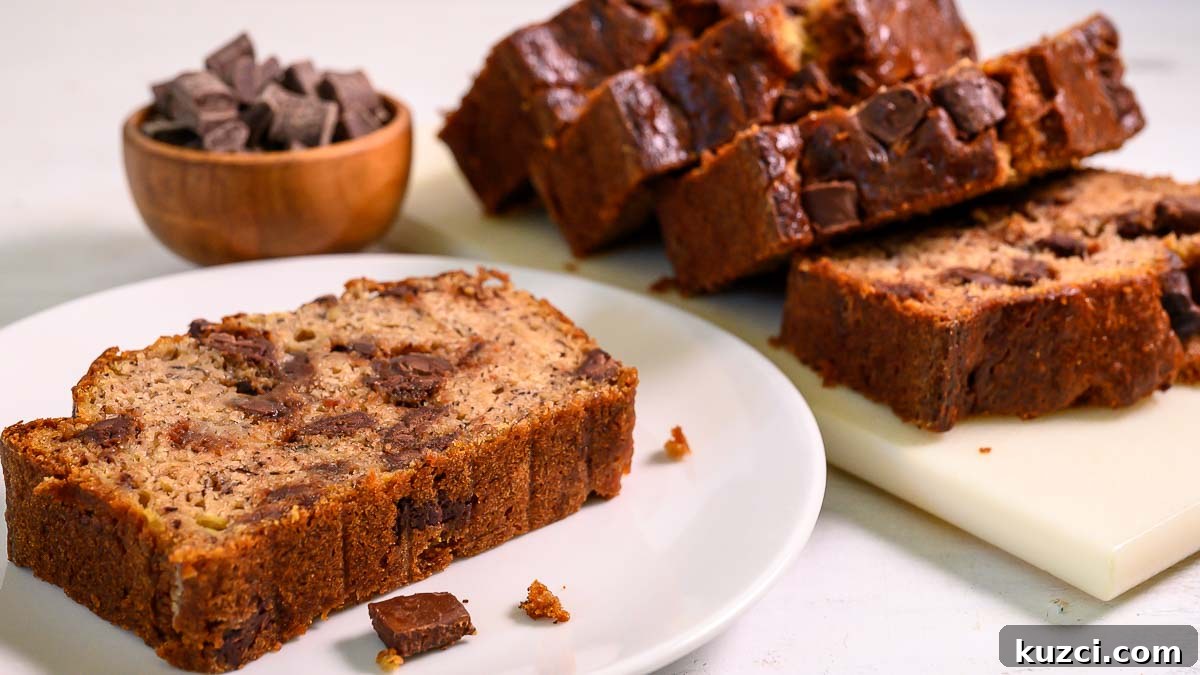 chocolate chunk banana bread slices on a plate and cutting board.
